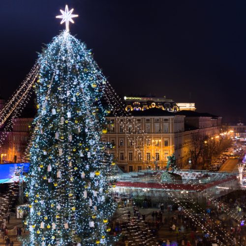 Christmas tree decorated with lights and Sophia Cathedral on background. Ukraine
