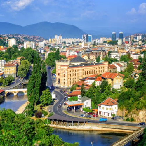 Aerial view of Sarajevo, the capital of Bosnia and Herzegovina, with Latin Bridge, Miljacka River, National Library and the modern city