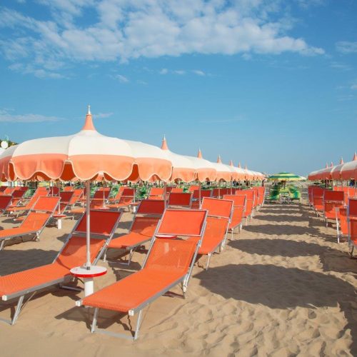 orange-umbrellas-chaise-lounges-beach-rimini-italy-destination