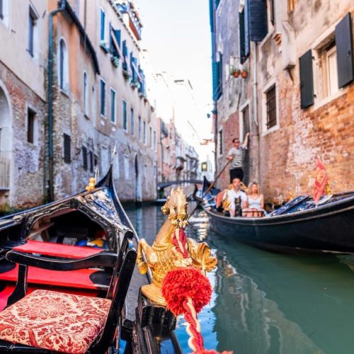 riding-traditional-gondola-down-narrow-canals-venice-italy